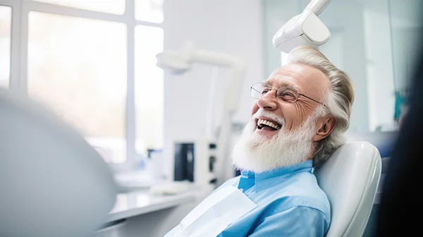  A bearded older gentleman smiling in the dentist chair ready for a dental cleaning